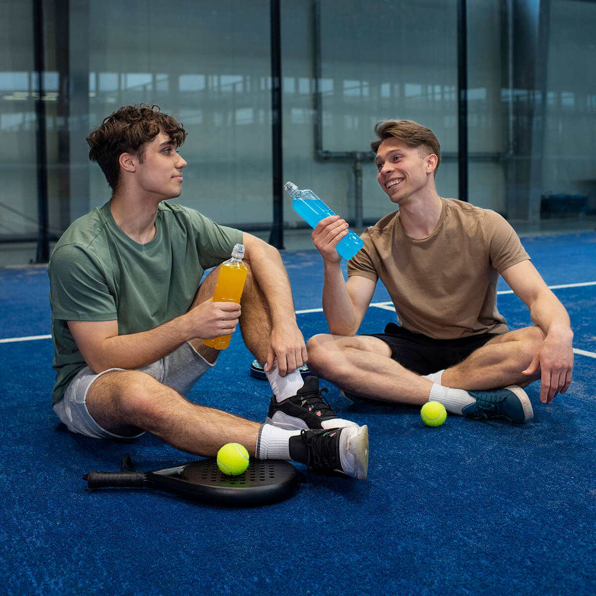 Two young men resting after a pickleball game at The Picklebarn ETX in Chandler TX